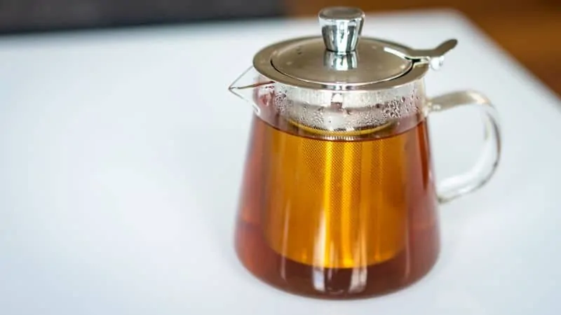 glass teapot with infuser full of brewed tea