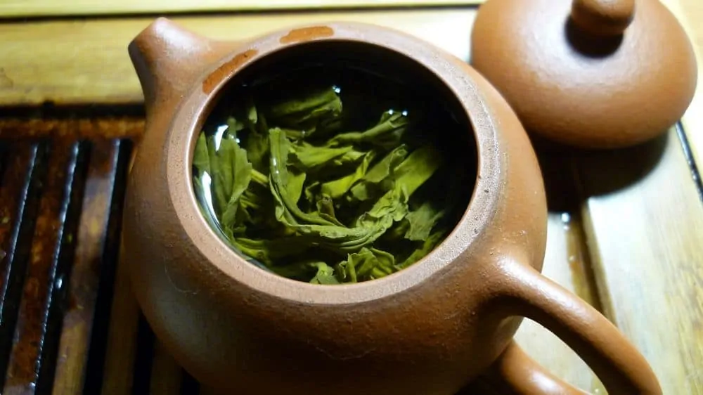 Green tea leaves in clay pot