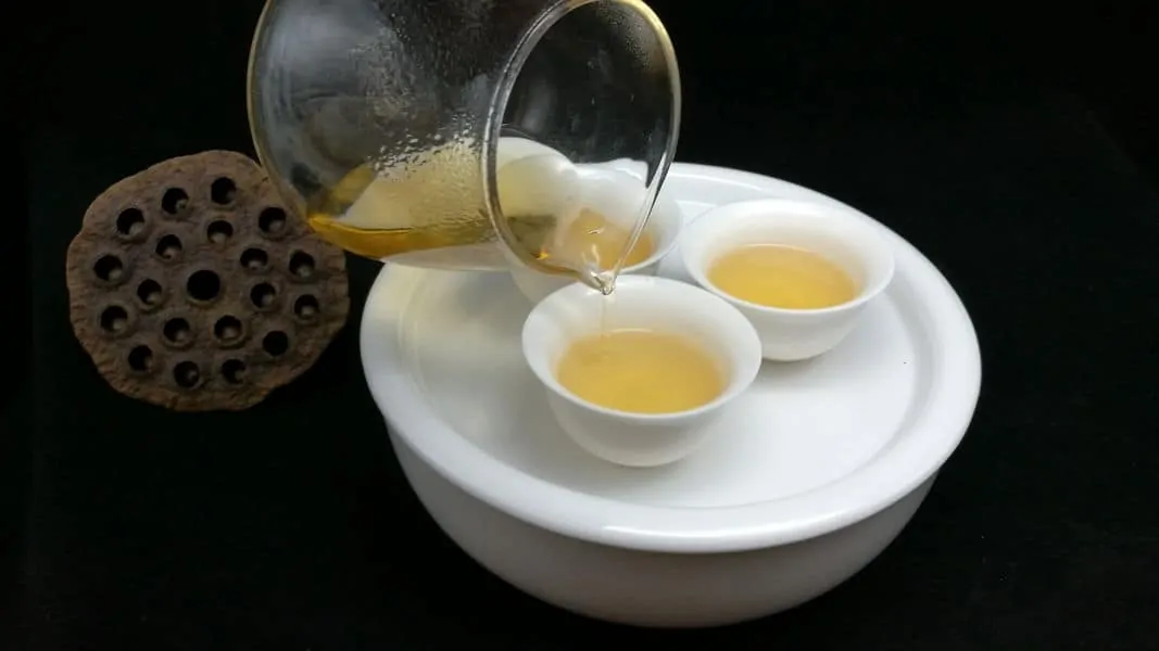 Pouring tea into tea cups