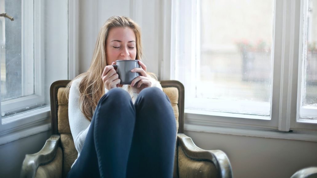 Sick woman drinking tea