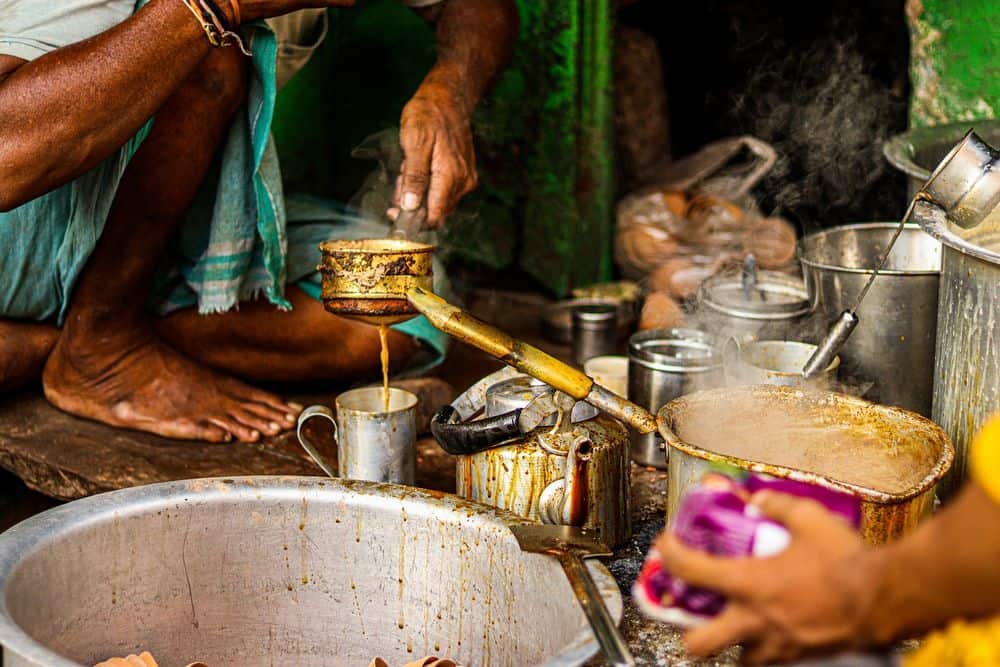 man making chai in india