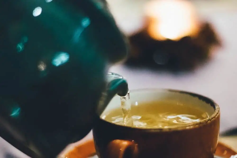 pouring cup of green tea