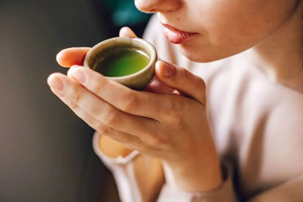 woman holding cup of matcha