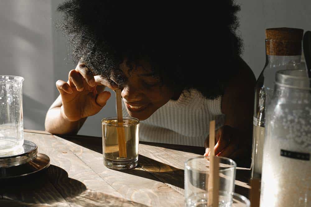 woman mixing green tea shot